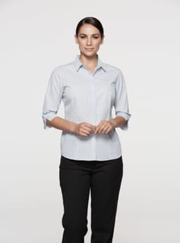 A light blue button-up shirt with 3/4 sleeves, featuring a collar and a logo. Suitable for women's wear.