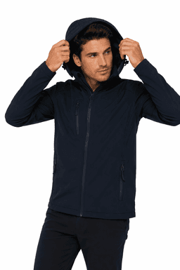 A man wearing a navy soft shell jacket with a hood, featuring zippered pockets and a fitted design.