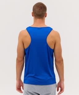 A man wearing a blue sleeveless singlet, viewed from the back, with grey shorts. The singlet features a logo.