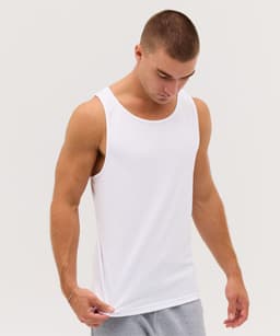 A man wearing a plain white singlet, looking down with a neutral expression. The singlet has a logo on it.