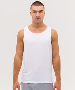 A white singlet shirt displayed on a model with short hair. The shirt has a branding logo.