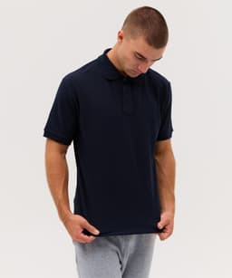 A navy Delta Polo shirt featuring a classic collar, short sleeves, and a logo on the chest.