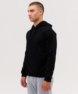 A black hoodie with a front pocket and a drawstring hood, worn by a model in a neutral setting.