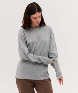 A long sleeve tee in grey, with a relaxed fit and a simple design, featuring a branding logo.