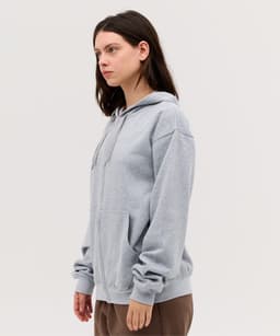 A grey hoodie with a front pocket and drawstring hood, featuring a logo on the chest.