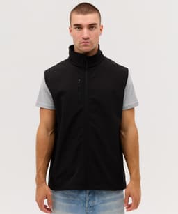 A black softshell vest with a zip front, featuring a chest pocket, worn over a grey short-sleeve shirt.