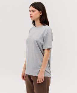 A grey T-shirt with a loose fit, featuring short sleeves and a round neckline. It has a branding logo.