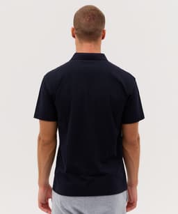 A navy polo shirt featuring a classic collar and short sleeves, with a logo on the back.
