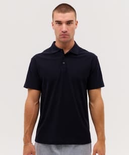 A navy polo shirt features a collar and short sleeves, with a logo on the chest. Ideal for casual wear.