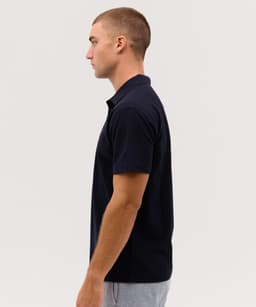 A navy polo shirt for men, featuring a classic collar and short sleeves, with a visible branding logo.
