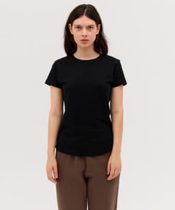 A black women's essential tee, featuring short sleeves and a round neckline, displayed on a model.
