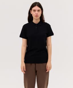 A black women's polo shirt with a collar, short sleeves, and a logo on the chest, displayed on a model.