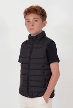 A black puffer vest with a zip front and side pockets, worn by a young model.