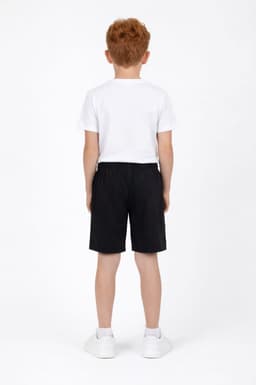 Youth Core Shorts in black, featuring an elastic waistband, shown on a child from the back, wearing a white t-shirt and shoes.