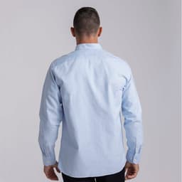 A light blue men's button-up shirt with long sleeves and a logo on the back.