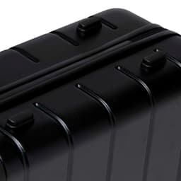 A black hardcase trolley with ridged design, featuring multiple zippers and handles.
