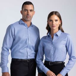 A blue button-up shirt worn by a man and a woman, featuring a collar and a logo.