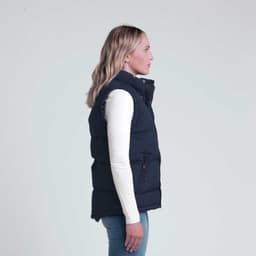 A navy puffer vest displayed on a model, featuring a high collar and zippered pockets.