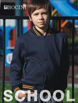 A navy bomber jacket with yellow trim, designed for kids, displayed on a young boy in an outdoor setting.