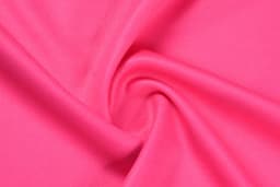 A close-up of smooth, stretchy fabric in a vibrant pink colour, showing its texture and folds.