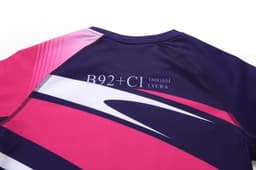 A purple and pink anti-chlorine bathing suit featuring a branded logo and a modern design.