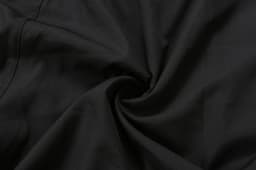 Black school wear shorts displayed in a twisted fabric arrangement, highlighting the material texture.