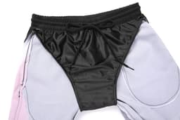Woven long shorts featuring a black waistband and a combination of light grey and pink fabric.