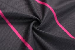 A black fabric featuring a textured pattern with vibrant pink stripes. It has a smooth, flowing appearance.
