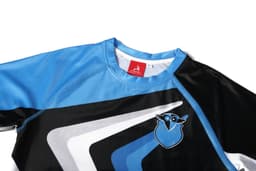A blue and black ANTI-CHLORINE PBT T-SHIRT with a logo on the front and a sporty design.