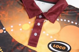 A customised Aboriginal polo featuring a vibrant design with shades of orange and maroon, and a logo on the side.