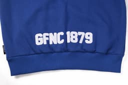 A blue polar fleece hoodie featuring a white logo and text at the bottom. It has a snug fit at the waist.