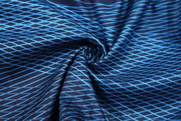 A fabric featuring a blue and black diamond pattern, perfect for sublimation beach shorts.