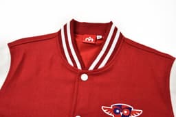 A red custom-made letterman jacket with white sleeves and a decorative logo on the front.