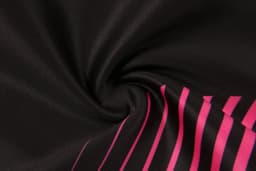 A black fabric with pink stripes, showcasing a smooth, swirling texture. The material appears soft and flexible.