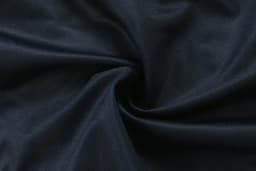 A dark navy fabric with a smooth texture, featuring a swirl pattern.