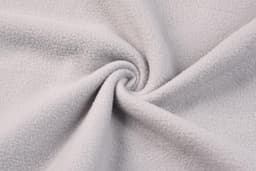 A polar fleece fabric in a light grey shade, featuring a soft and smooth texture with spiralling folds.