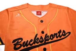 An orange baseball tee with full buttons, featuring black text and a logo on the chest.