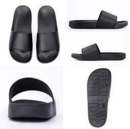 Black slippers featuring a simple design with a flat sole and a wide strap. Contains a logo on the side.