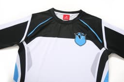 A black and white long-sleeve swimwear top with blue accents and a logo.