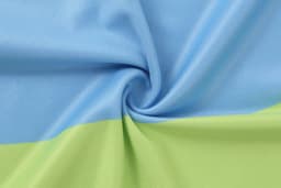 A fabric swatch in light blue and green, featuring a smooth texture and spiral pattern.