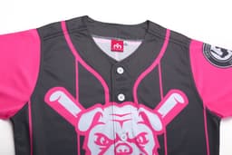 A full button baseball jersey featuring black fabric with bright pink sleeves and a graphic design, including a logo.