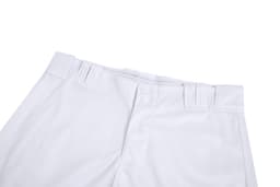 White baseball training pants featuring a button closure and waistband detailing, with a branded logo.