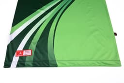 A green polo shirt featuring dynamic white and darker green designs, with a logo on the fabric.