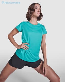 A turquoise women's T-shirt with a sleek design, paired with black shorts, featuring a logo on the shirt.