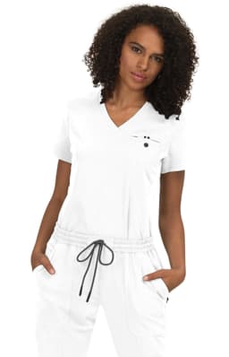 A woman wearing a white top with a V-neck and grey drawstring pants, featuring a logo on the top.