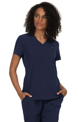 A navy blue v-neck top with short sleeves and a small logo, modelled by a woman with curly hair.