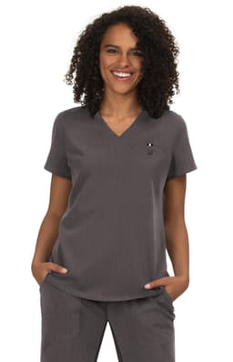 A woman wearing a grey top with a V-neck and short sleeves, featuring a small logo on the chest.