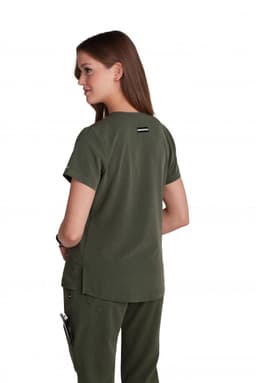 A woman wearing a dark green, short-sleeved top, viewed from the back. The top has a logo on the back.