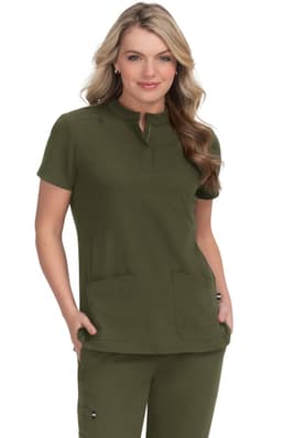 A green medical scrub top featuring a short collar and two front pockets, worn by a woman.