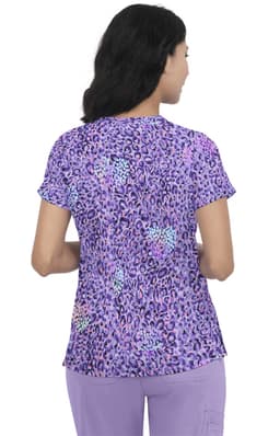 A woman wearing a purple leopard-print top with short sleeves, viewed from the back. The top features various shades of purple.